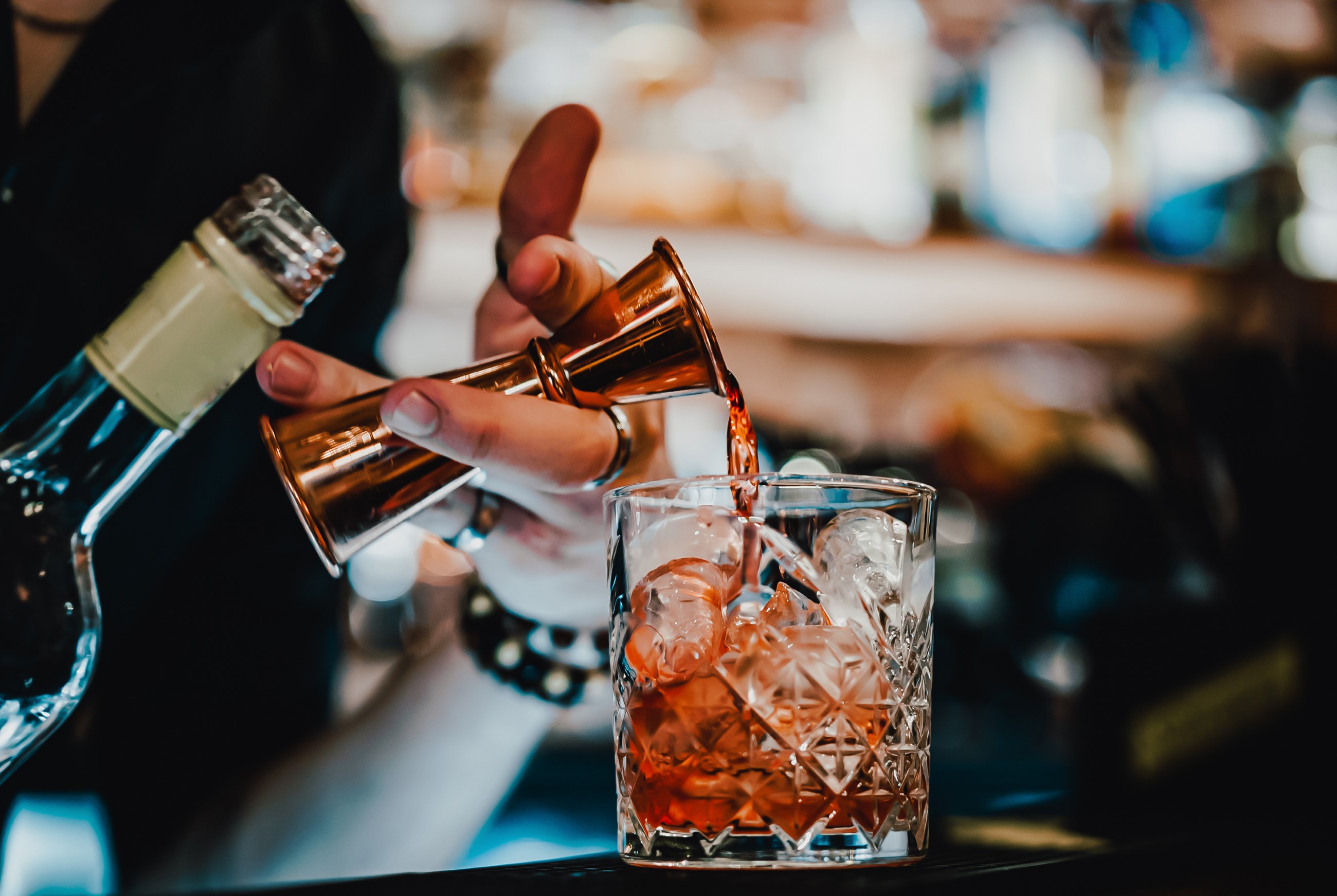 Bartender pouring a drink into a nice glass
